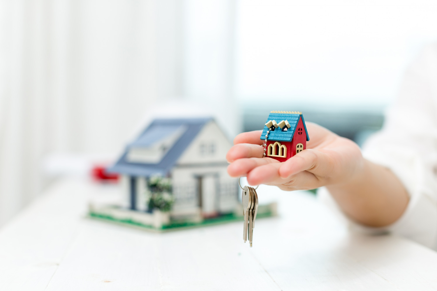 real-estate-agent-with-house-model-keys