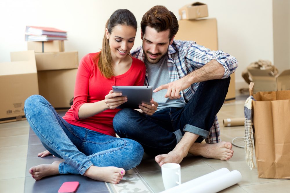 young-couple-with-digital-tablet-their-new-home